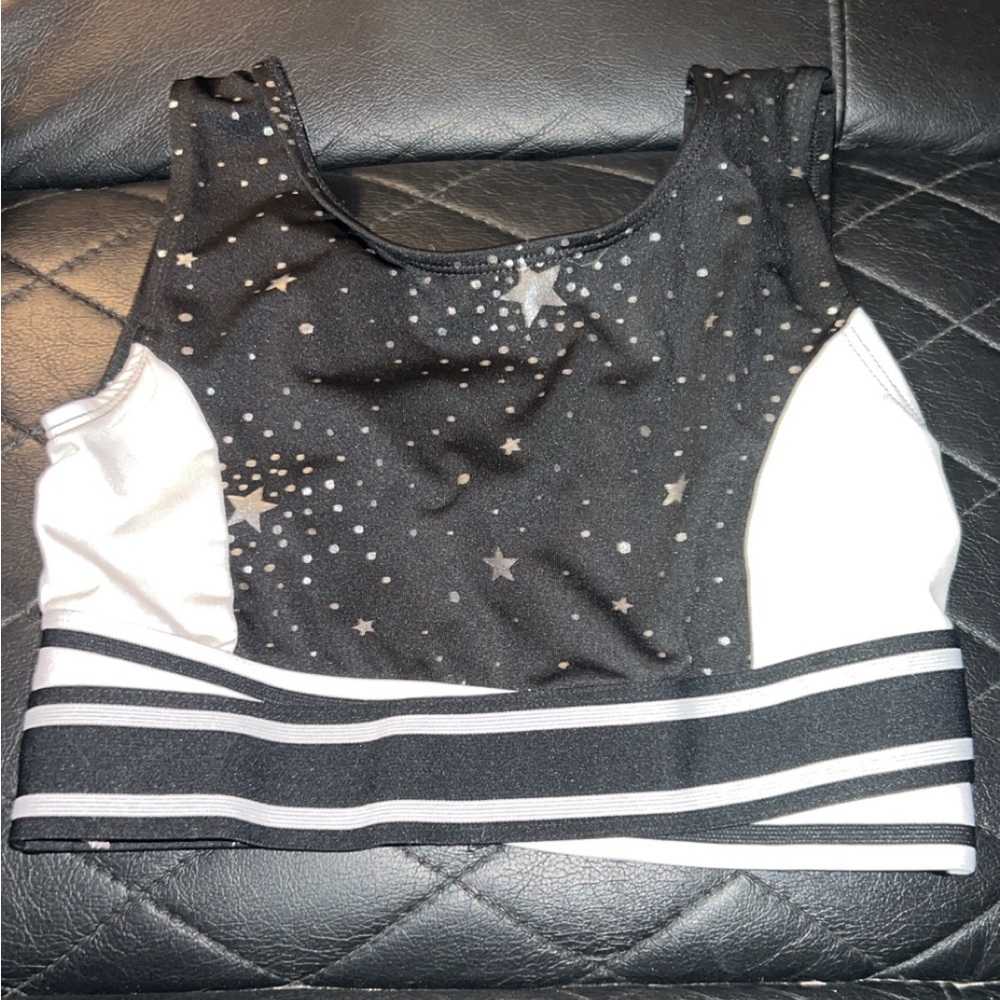 Black and white star print cheerleading leotard with white stripes. Size: L